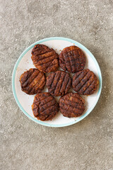 Burger cutlets close up on stone background, top view