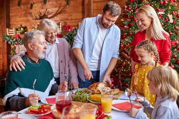family preparing christmas table together, spend time together at home on the eve of New Year 2021, going to celebrate