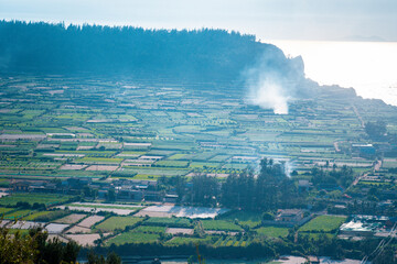 high view from Thoi Loi Mountain, fishing village and garlic fields at Ly Son island, Quang Ngai...