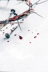 Bloody nails, crown of thorns, drops of blood on grey stone background. Good Friday, Passion of...