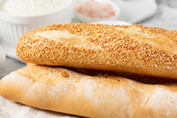 Baguette. Baguette on a light gray table. Homemade baguette. French bread closeup	