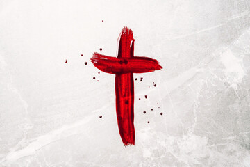 Christian cross painted with red blood on stone background. Copy space. Good friday. Passion,...