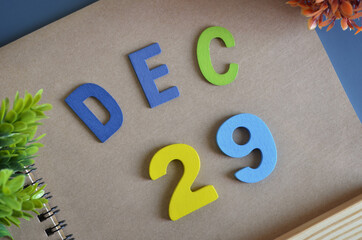 December 29, Cover design in natural concept with a brown notebook and colorful wooden alphabet.