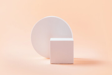 Abstract empty geometric shape podium for product on pastel beige background. Copy space. White cube on natural backdrop. Pedestal template for advertising. Trendy minimal concept. Mock up
