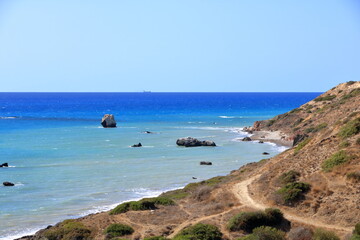 Aphrodite Beach with Stone Rocks in Aphrodite bay of Mediterranean sea water, blue sky in sunny day...