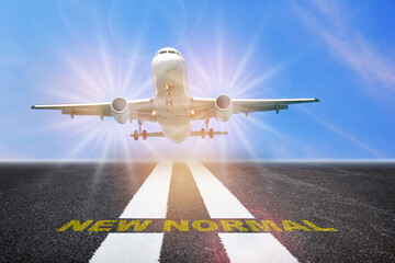 Fototapeta premium Airplane business travel with new normal concept and economic recovery after covid-19 impact to transport industry idea. Commercial plane ready for landing or taking off with new normal word on runway