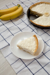 Homemade Tasty Banana Cream Pie on cloth, low angle view.