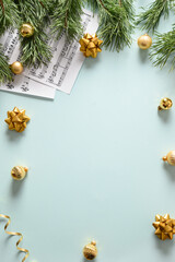 Music sheets for Christmas Carols and sings decorated golden balls on blue background. View from above. Vertical format.