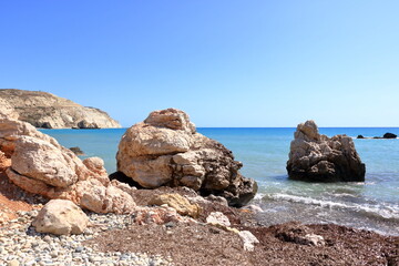 Aphrodite Beach with Stone Rocks in Aphrodite bay of Mediterranean sea water, blue sky in sunny day...