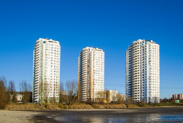 Fototapeta na wymiar three new high-rise buildings on the lake shore