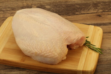 Raw whole chicken breast with skin