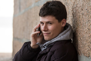 smiling man using smartphone or mobile phone