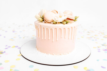 White beautiful cake decorated with flowers, birthday and wedding cake, on isolated white background