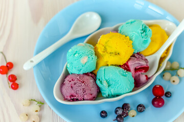 top view of various colorful balls of berry ice cream, healthy homemade sorbet made from blueberries, cranberries and currants