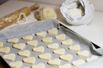 Fototapeta na wymiar Making homemade sugar cookies in the shape of a heart. A gift for Valentine's Day.