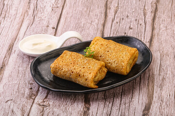 Staffed pancakes served sour cream