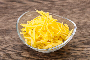Shredded yellow cheese in the bowl
