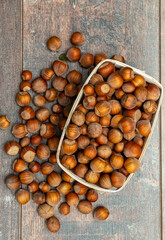 Hazelnuts in small crate on rustic background