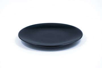Empty Black plate isolated on white background side view, selective focus