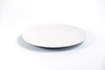 Empty White plate isolated on white background side view, selective focus