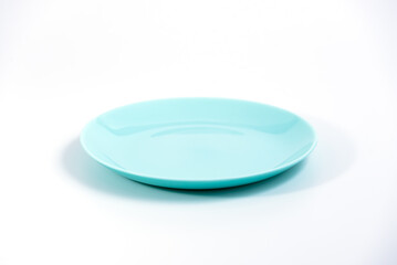 Empty Turquoise plate isolated on white background side view, selective focus