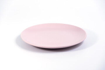 Empty Pink plate isolated on white background side view, selective focus