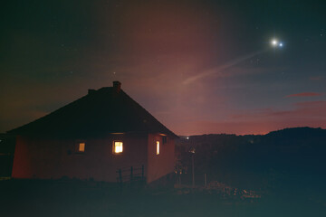 Milky Way stars and suburb countryside silhouettes.
