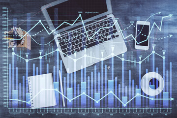 Double exposure of forex chart drawing over table background with computer. Concept of financial research and analysis. Top view.