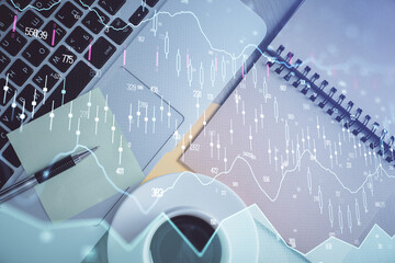 Stock market graph and top view computer on the table background. Double exposure. Concept of financial education.