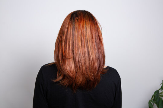 Half Body Portrait Of Rear View Of A Brown-haired Woman Wear Black Clothes Over White Background