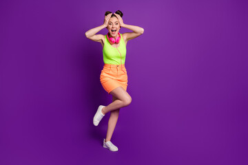 Fototapeta na wymiar Full length body size view of pretty amazed cheerful girl listening disco having fun dancing isolated on bright violet color background