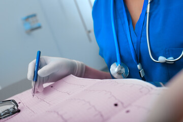 Female medical doctor working with patient examination results in her office