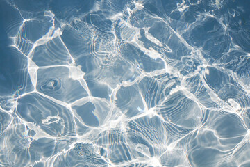 Blue water swimming surface with bright sun light reflections. for background