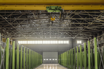 Hall of engineering plant shop with overhead crane. Distance perspective. Long production span....