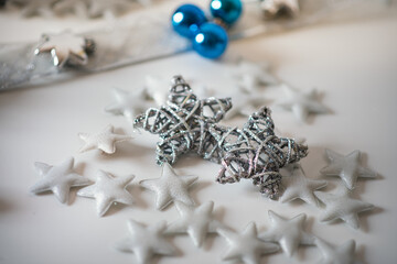 Christmas decoration on royal blue background. Top view on stars, wings and ornaments. 