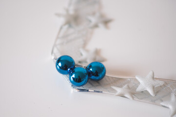 Christmas decoration on white background. Cozy silver blue christmas star and christmas ornaments.
