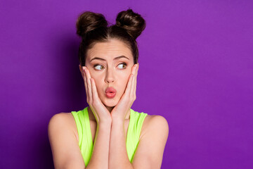 Photo of attractive lady two buns arms on cheekbones look empty space wear green singlet isolated violet color background