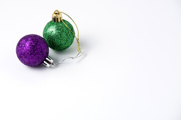 Christmas decoration ball two purple and emerald on a white background