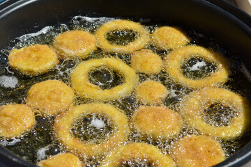 Pumpkin rings in deep fryer.