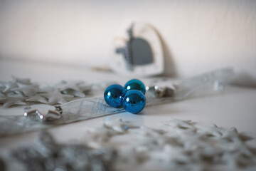 Christmas decoration on white background. Cozy silver blue christmas star and christmas ornaments.