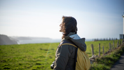 Photographer seeing the green meadow coast landscape