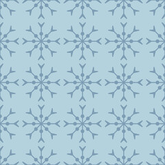 Blue seamless pattern with simple blue snowflakes for Christmas and New Year design, wrapping paper, wallpapers. 
