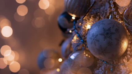 Festive background with a decorated Christmas tree, New Year's toys, holiday lights, neon lights, garland. Dark background with blurred bokeh.