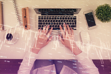 Double exposure of woman hands working on computer and forex chart hologram drawing. Top View. Financial analysis concept.