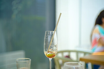 Brunch Time in Restaurant, Beautiful Fresh Cold Tasty Cocktails in Wine Glass with nature color Paper Straws.
