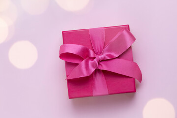 pink gift with christmas lights bokeh around