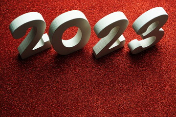 2023 Happy New Year with space copy on red glitter background