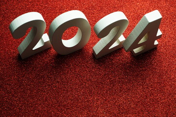 2024 Happy New Year with space copy on red glitter background