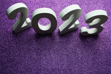 2023 Happy New Year with space copy on purple glitter background