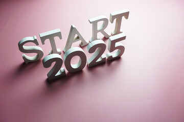 Start 2025 alphabet letter on pink background